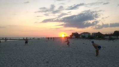 iron port beach frisbee game - Beach frisbee under sunset